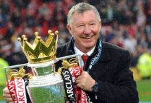 Sir Alex Ferguson Holding Up A Premier League Title
