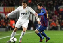 Cristiano Ronaldo and Lionel Messi Jostling for the Ball