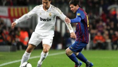 Cristiano Ronaldo and Lionel Messi Jostling for the Ball