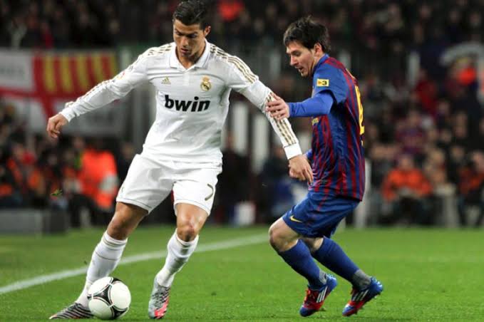 Cristiano Ronaldo and Lionel Messi Jostling for the Ball